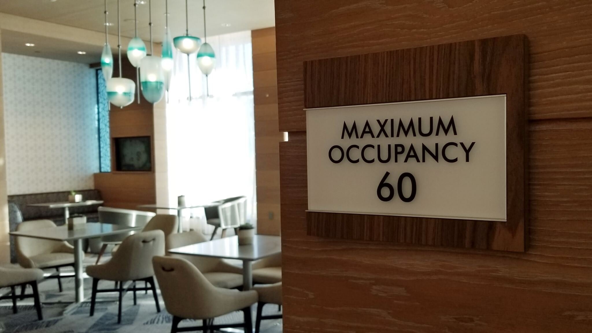 Maximum occupancy limit sign representing 1968 Building Code regulations